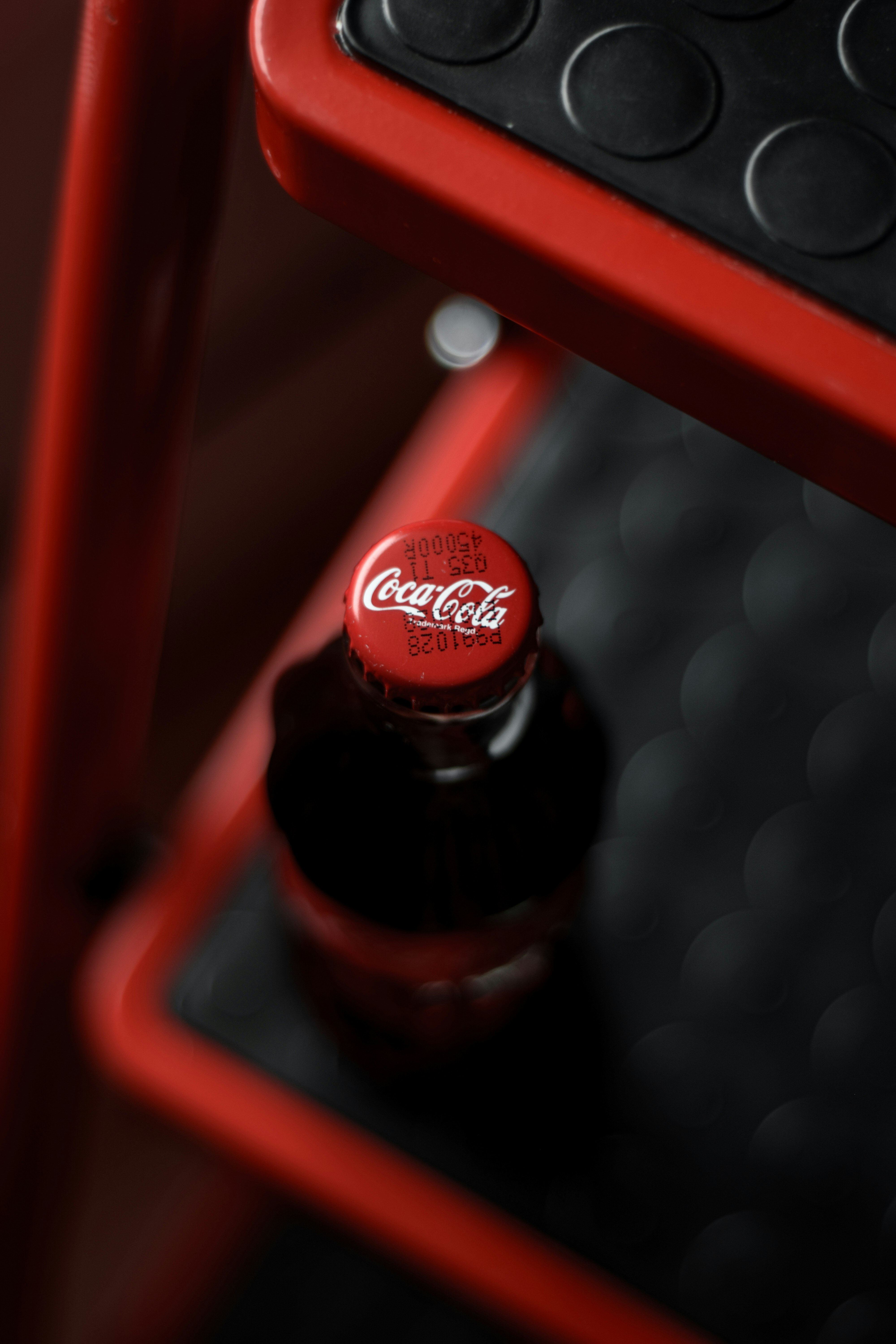 coca cola bottle on red plastic crate